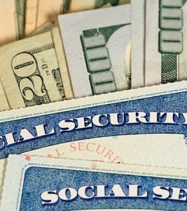 USA Social security cards laid on dollar bills - Indiana Connection