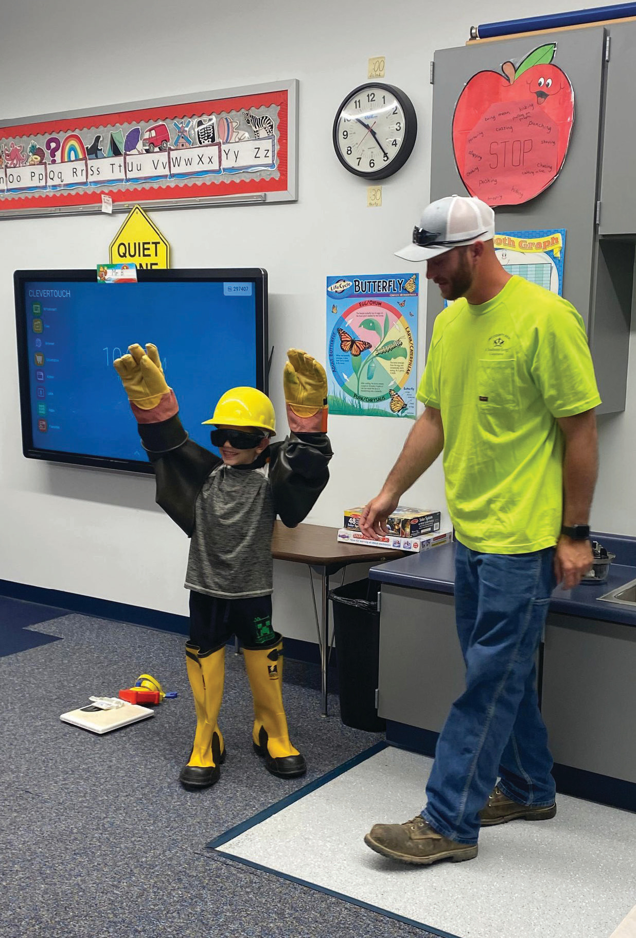 A student tries on protective gloves that linemen use daily.