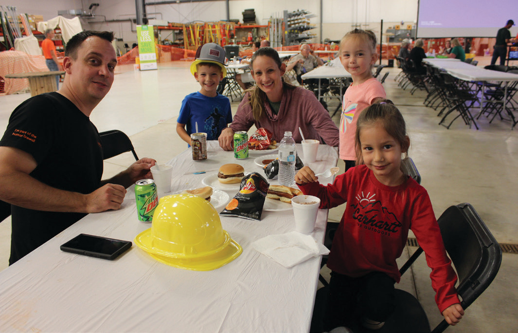 Members Michael and Crystal Dunlap enjoy dinner with their kids at the Annual Meeting. The meeting was held in-person for the first time in four years.