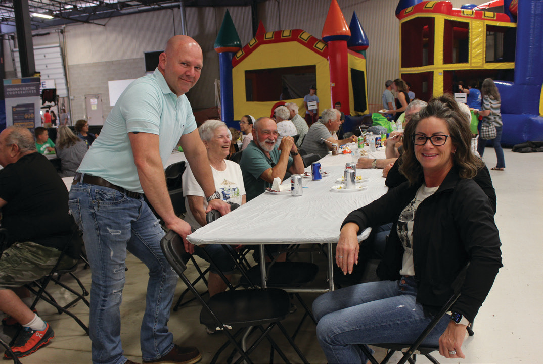 LaGrange County Sheriff Tracy Harker and his wife, Jen, pause their conversation with neighbors for a picture.