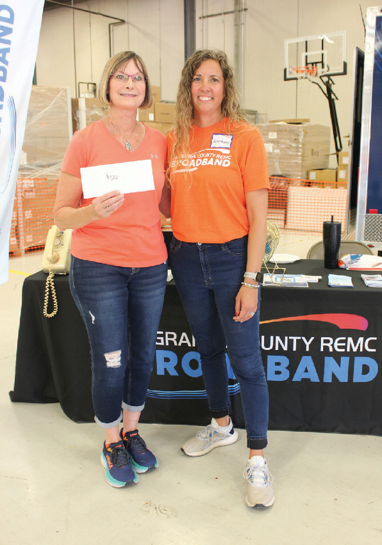 Sherry Severson, left, was the grand prize winner of $500 at the Annual Meeting. She was presented the cash prize by LaGrange County REMC’s Brittany Sams.