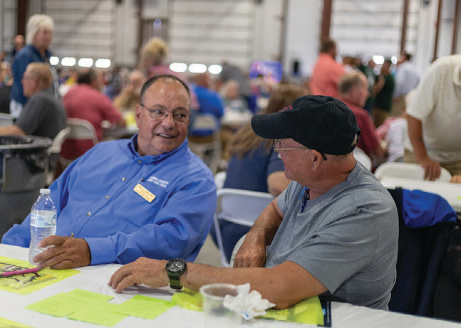 REMC Director Brian Hawkins visits with a member prior to the business meeting.