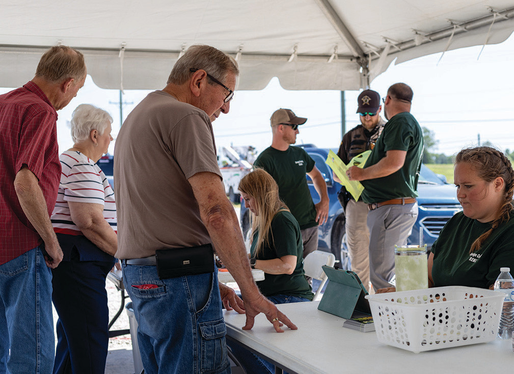 REMC employees Misty Tincher and Sarah Jenkins assist members in registering for the event.