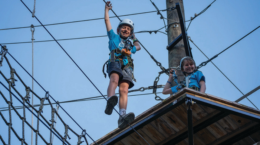 Camp Kilowatt camper on zipline