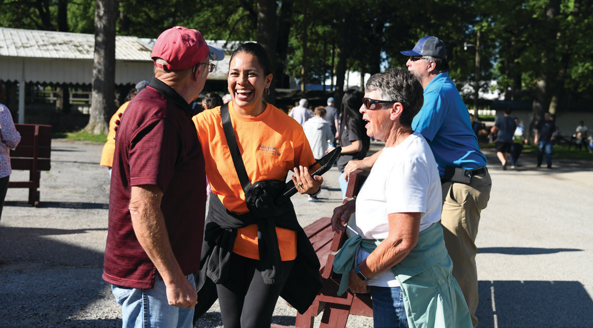 Administrative Assistant Elena Vargas smiles as she chats with members and registers them for the big event.