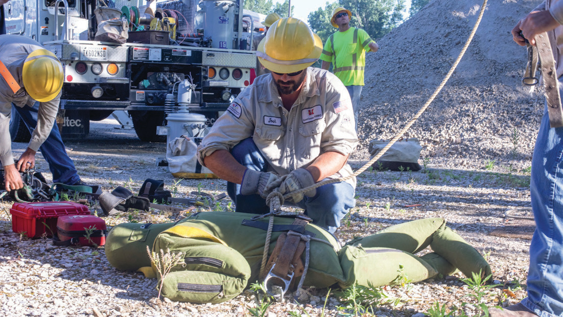 Lineman Joshua Salazar prepares the mannequin for another rescue during pole top rescue training.