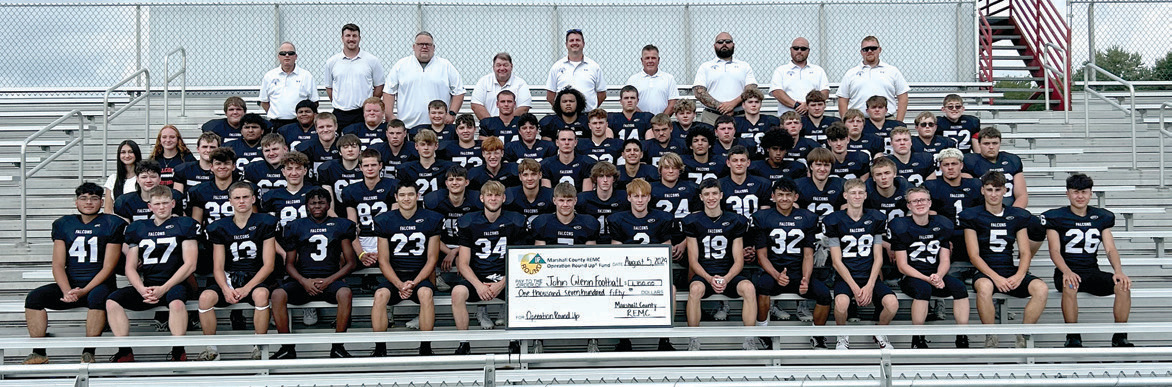 The John Glenn High School football team under Assistant Principal and Head Coach Ron Brown (top middle) and other coaching staff.