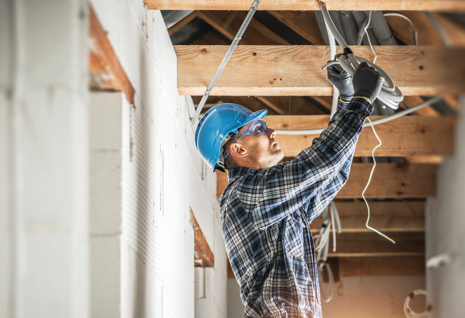 Man installing electrical wire