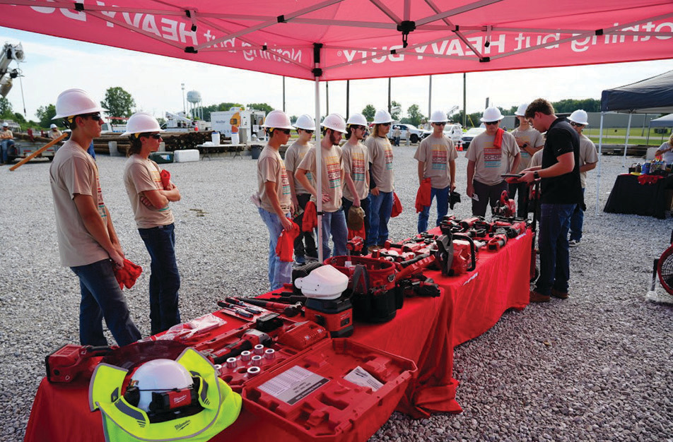 On the final day of camp at Henry County REMC, summer cooperative camp participants gather around the Milwaukee Tools demo tent.