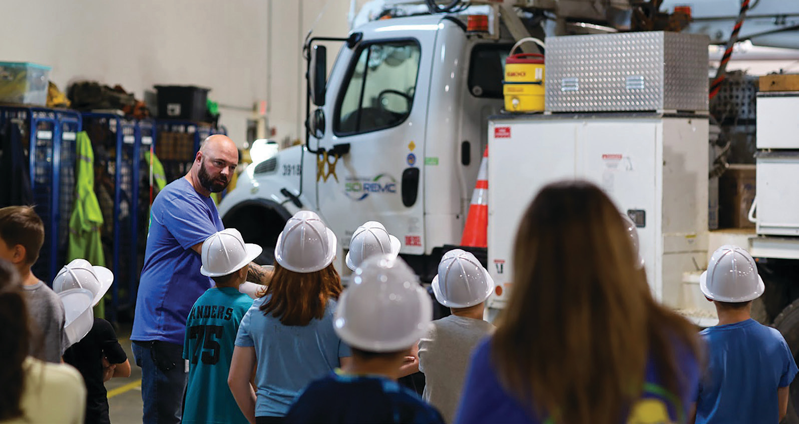 Participants at South Central Indiana REMC’s Energy Explorers Camp listen during a warehouse tour.