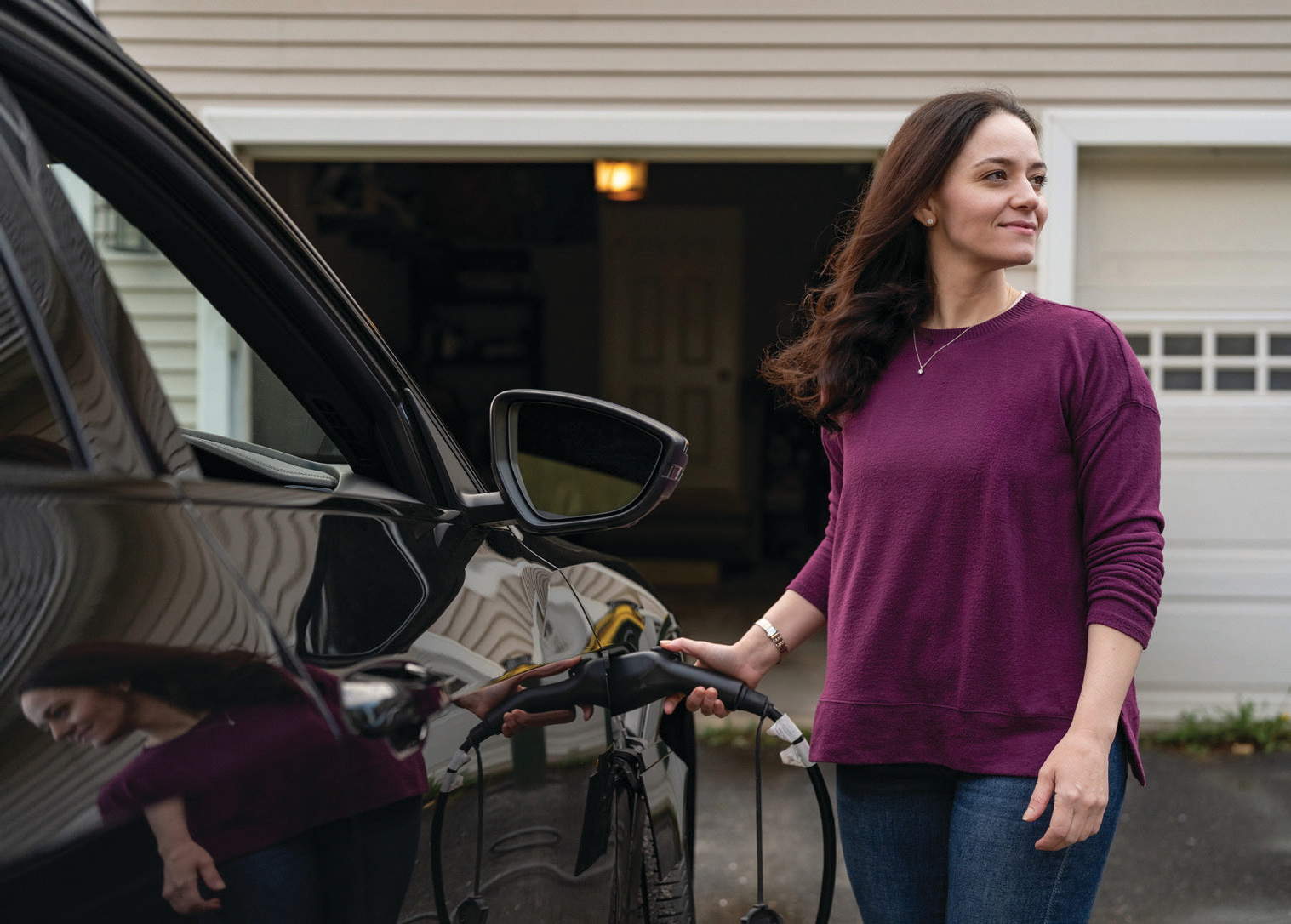 Woman charging an EV