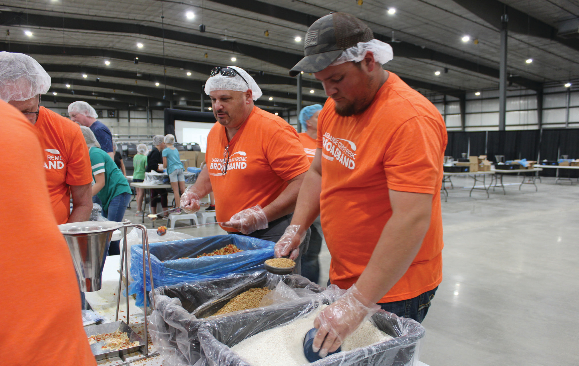 LaGrange County REMC’s Jake Taylor, left, and Jeff Patrick packed meals to support Indiana’s Electric Cooperative Community Day.