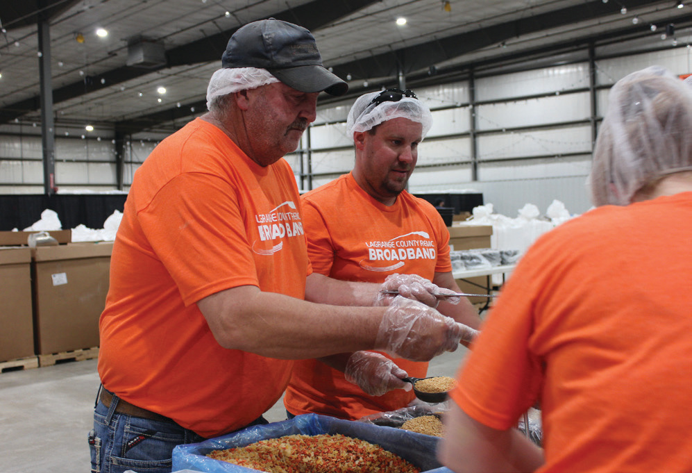 LaGrange County REMC’s Chris Mynhier, left, and Cole Howe help prepare MannaPack Rice.