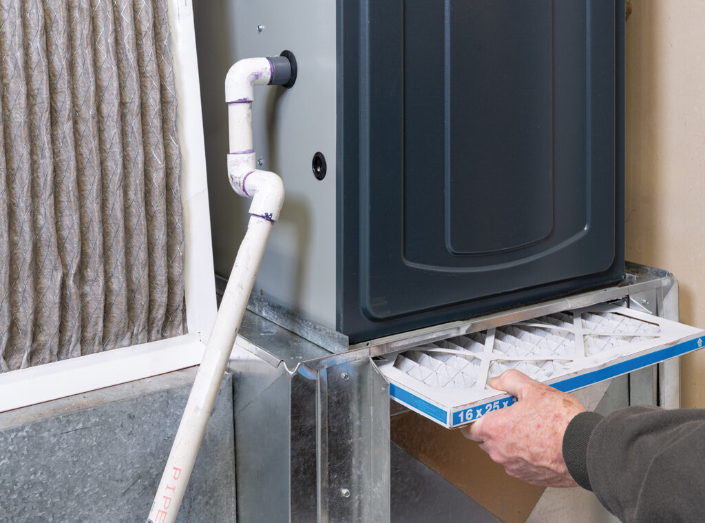 Person changing furnace filter