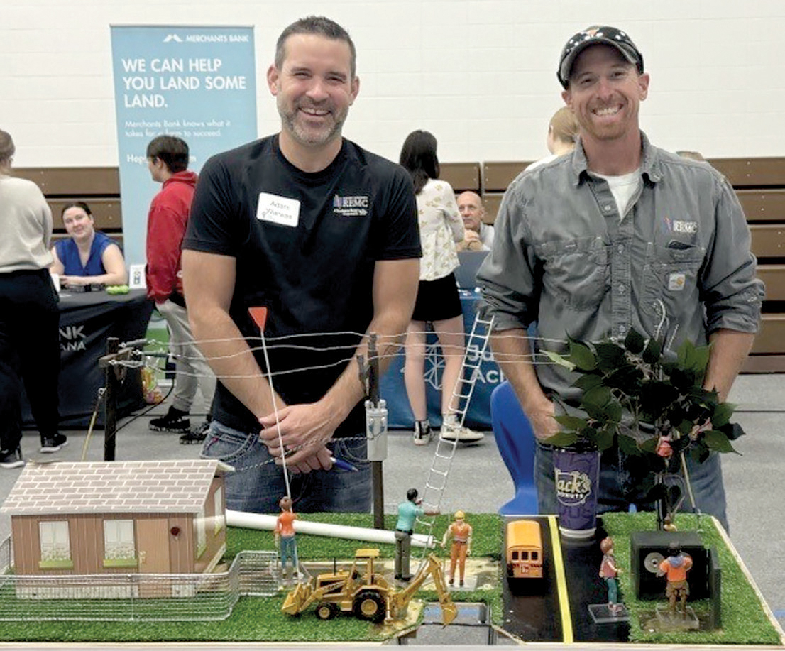 Adam Warwas, chief operating officer, and Tyler Powell, journeyman lineman, demonstrate the importance of electrical safety.