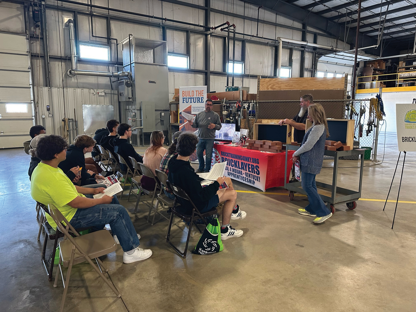 Students listen to presentation at Trades Camp