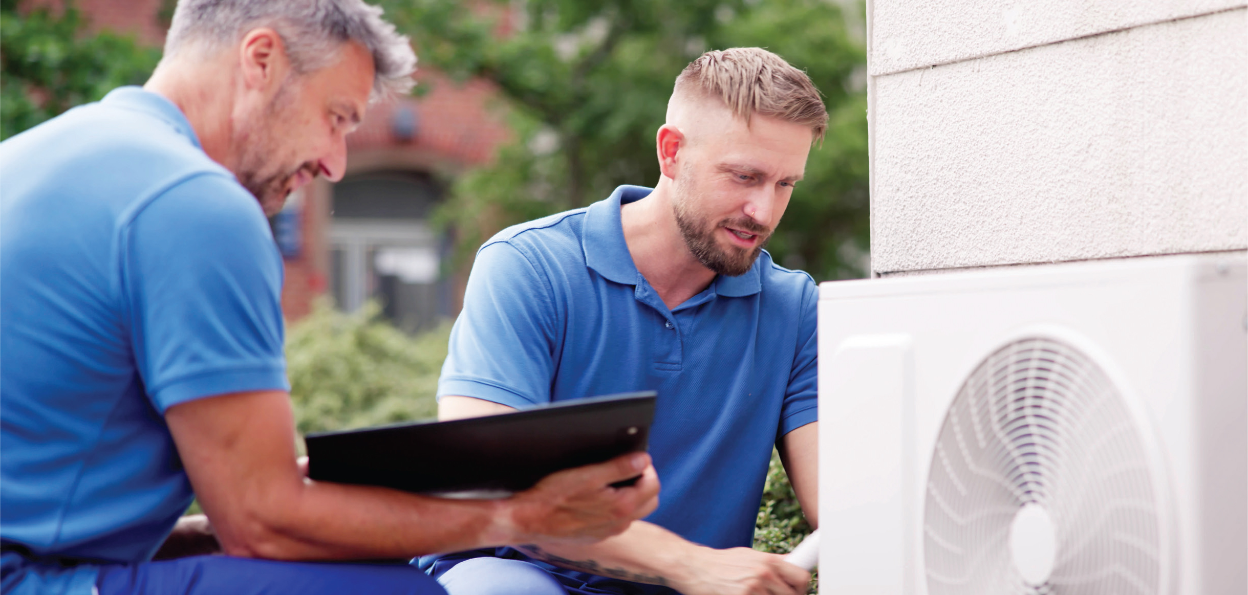 Men looking at HVAC system